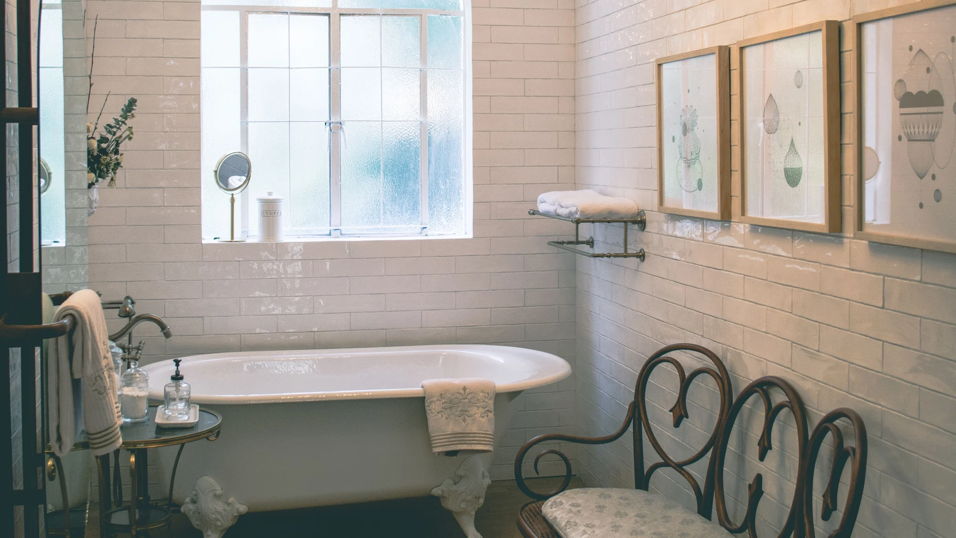 The family bathroom at Wraycombe House, with a roll-top bath under an arched window