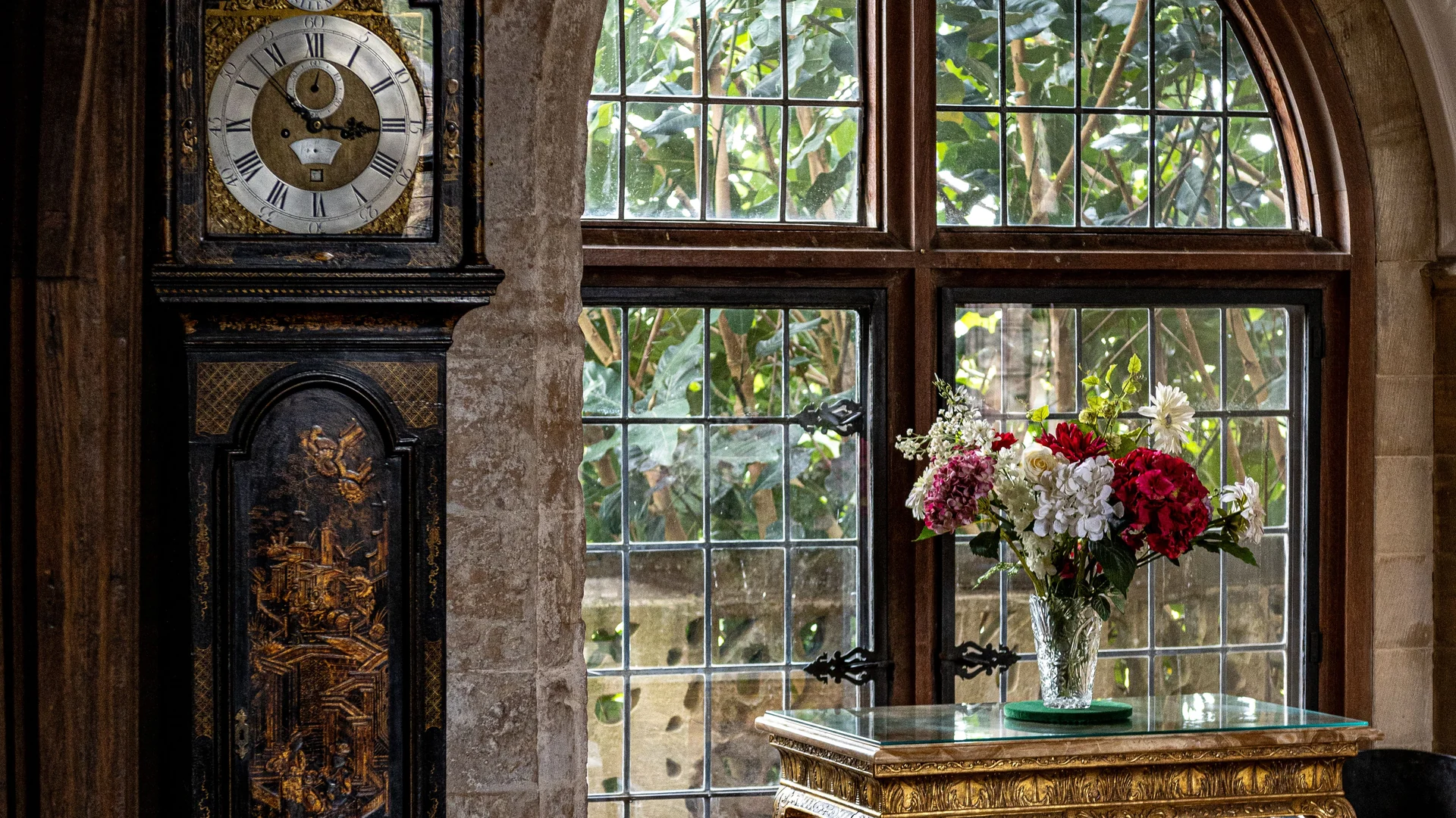 The entrance hall at Wraycombe House, with a chamfered stone arch and a tall leaded window
