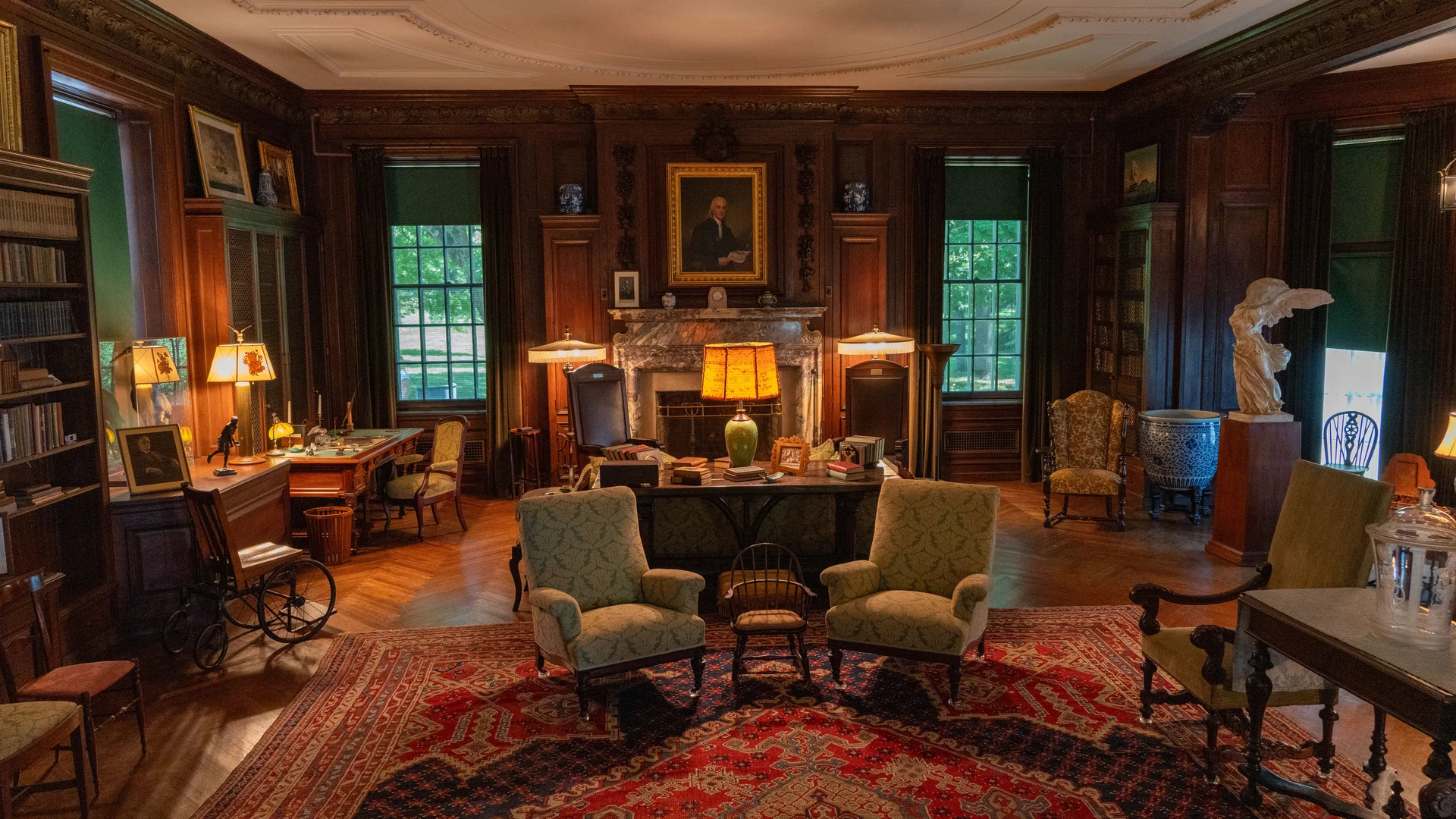 The library at Wraycombe House, panelled in oak with bookcases and two bay windows