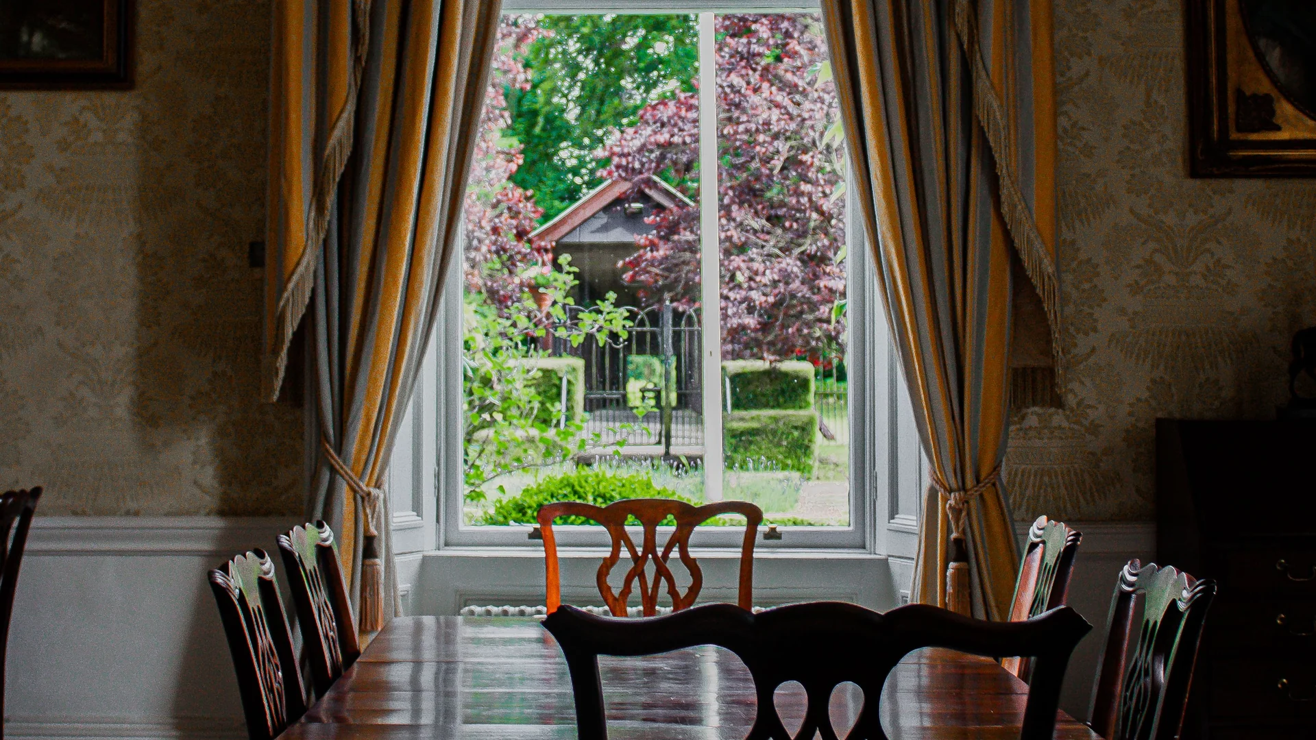 The morning room, with a tall sash window looking down the garden